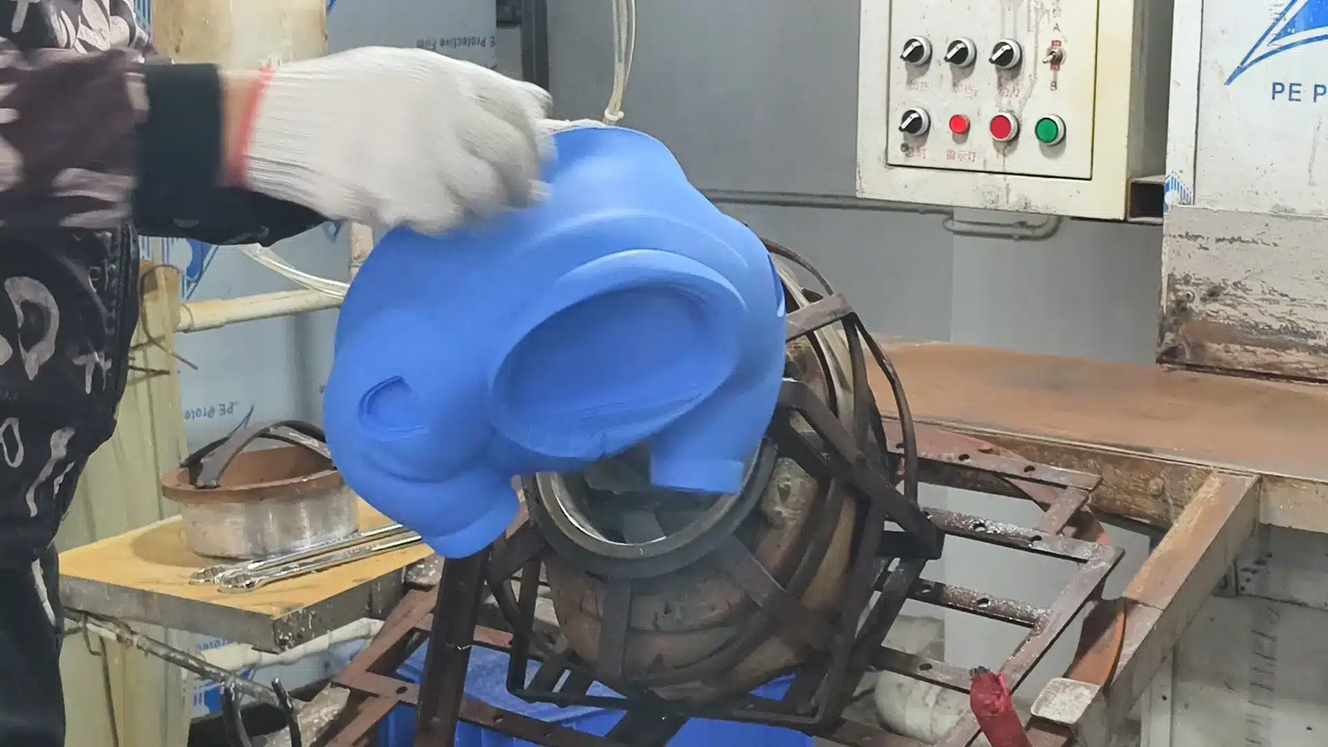 Manual demolding of soft vinyl parts from copper molds by skilled workers using pliers step 5