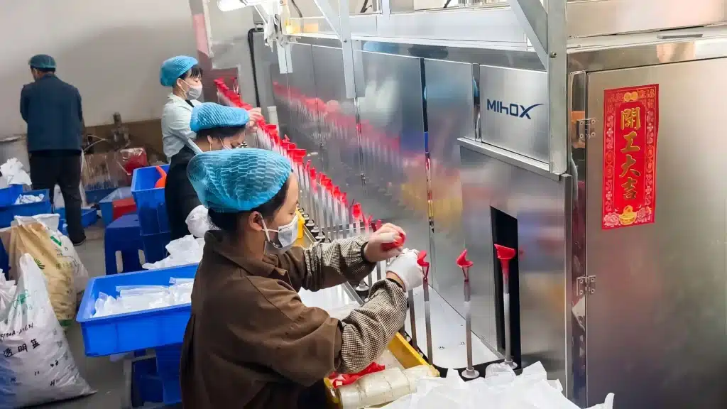 Professional mass production line at MIHOX factory, demonstrating the expert assembly process for bulk custom figure manufacturing to ensure quality control